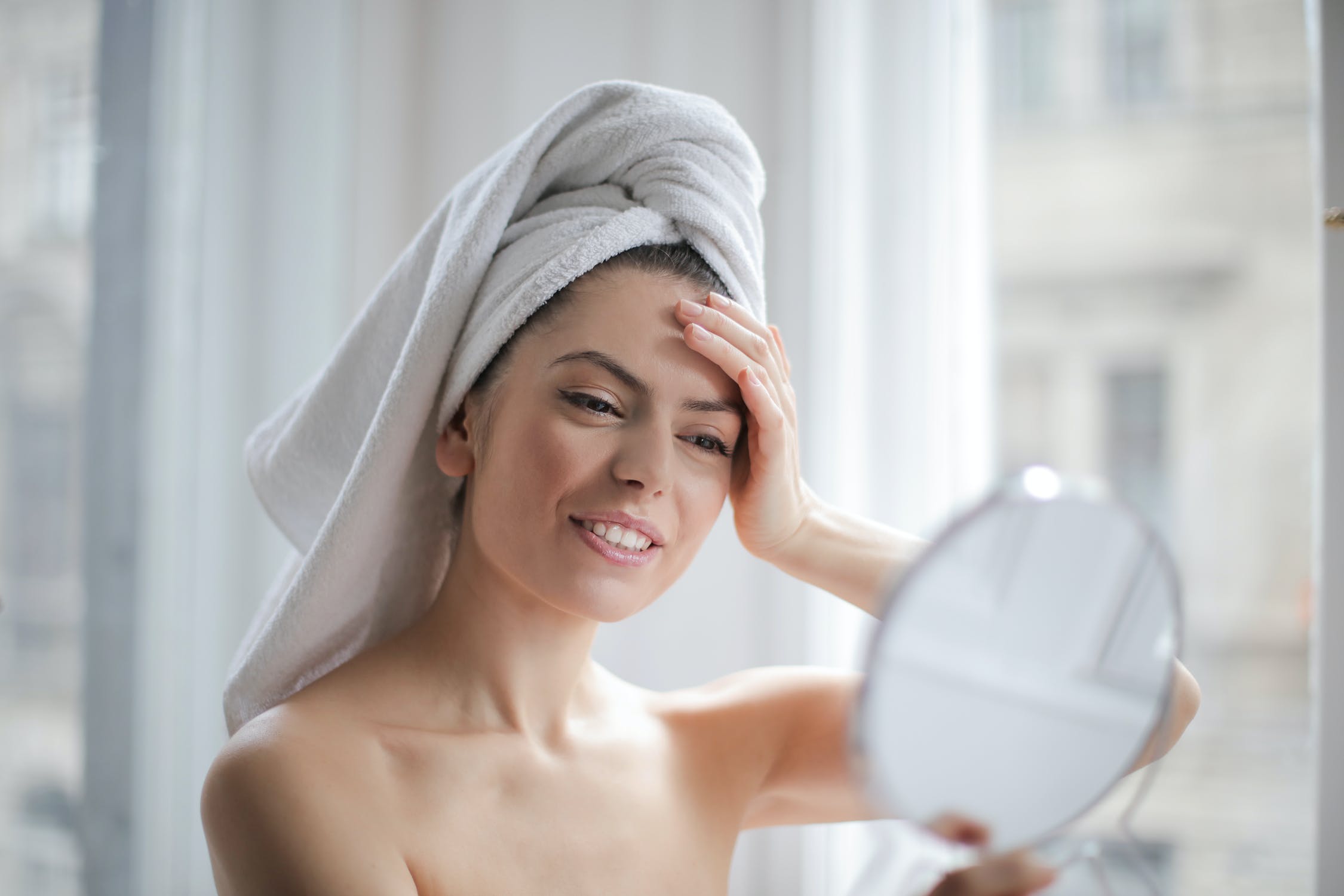 Collagen serum lady looking at mirror